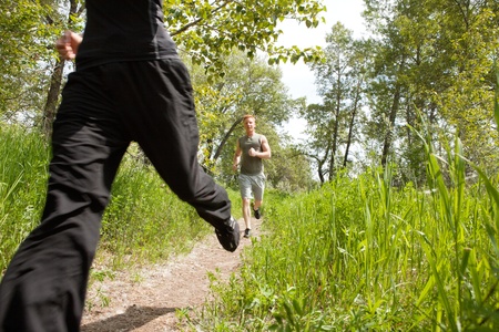 Happy men jogging at the park with his friendの写真素材