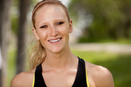 A portrait of a happy female jogger smiling at the cameraの写真素材