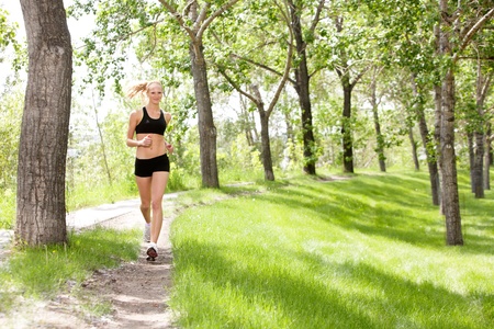 Portrait of a young beautiful smiling woman joggingの写真素材