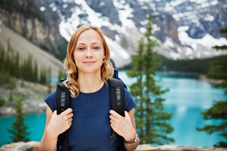 Portrait of attractive female hiker with her backpack against scenic viewの写真素材