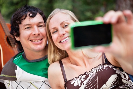 Happy young couple taking photo of themselvesの写真素材