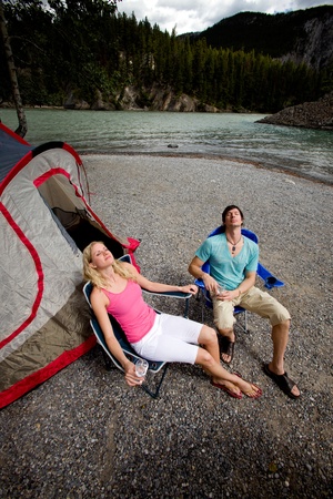 A couple camping in the wildernerss, relaxing in the mountainsの写真素材