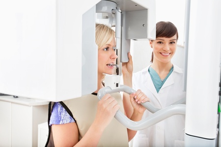 A young dentist taking a panoramic digital X-ray of a patient`s teethの写真素材