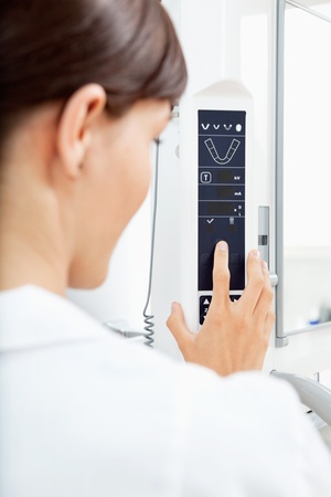 A detail of a young woman using a panormaic digital X-ray machineの写真素材