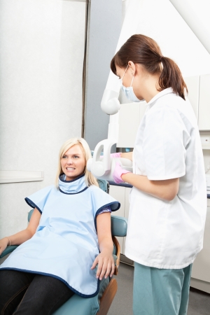 Female dental assistant taking oral x-ray of a patientの写真素材
