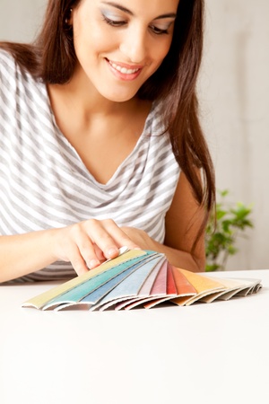 A woman looking at various flooring color swatchesの写真素材