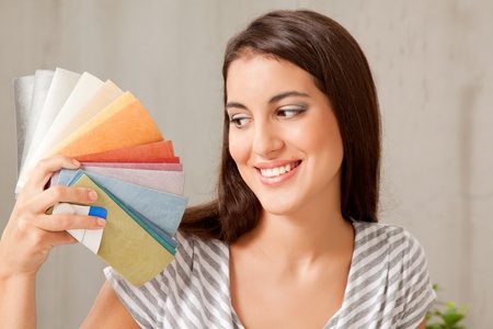A young femail looking at a group of color swatchesの写真素材