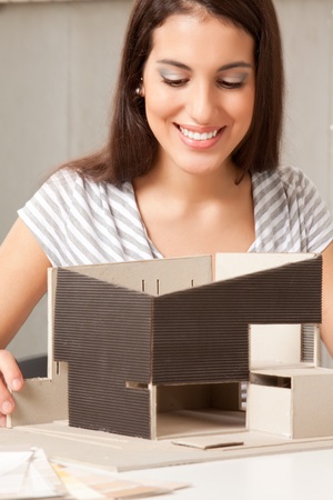 A young design student or architect building a house modelの写真素材