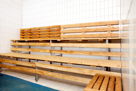 An empty sauna interior with tile walls and wood seatsの写真素材