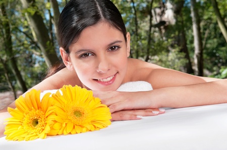 Portrait of fresh and beautiful young woman with flowers aroundの写真素材