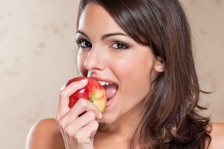 Portrait of pretty young woman eating an appleの写真素材