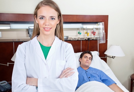 Confident female doctor with patient in hospitalの写真素材