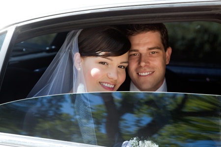 Portrait Of Newlywed Couple Smiling Sitting In Limousineの写真素材