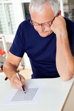 Senior man playing puzzle gameの写真素材