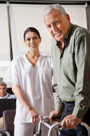 Nurse Helping Male Patient With Walkerの写真素材