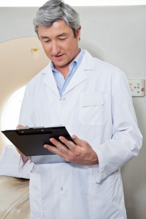 Doctor Writing On Clipboardの写真素材