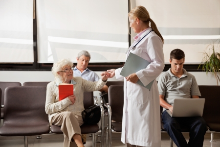 Doctor Holding Senior Woman s Handの写真素材