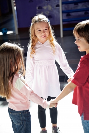 Children Playing While Holding Hands In Preschoolの写真素材