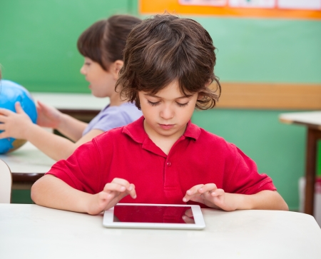 Boy Using Digital Tablet At Deskの写真素材