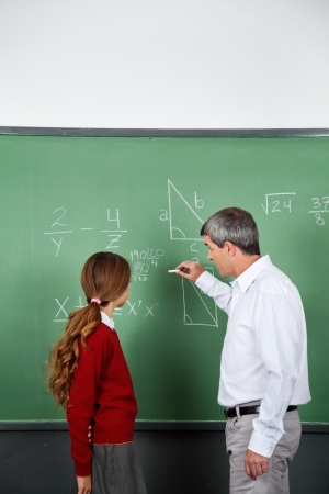 Teacher and student at blackboardの写真素材