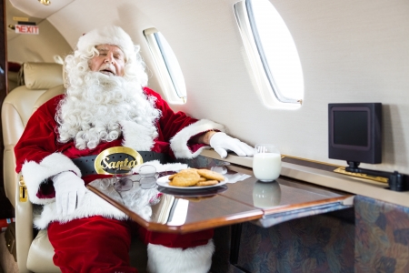 Man in Santa costume sleeping in private jetの写真素材