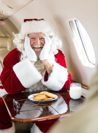 Portrait of happy man in santa costume with beard pulled downの写真素材