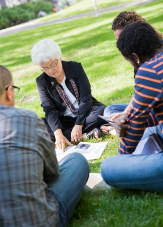 Casual outdoor study group with female professorの写真素材