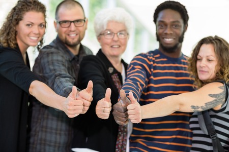 College students giving thumbs up with professorの写真素材