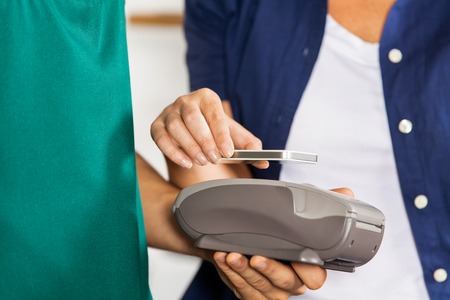 Customer Paying With Smartphone Using NFCの写真素材