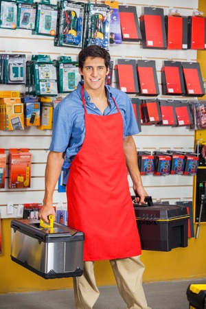 Salesman Holding Toolboxes In Hardware Shopの写真素材