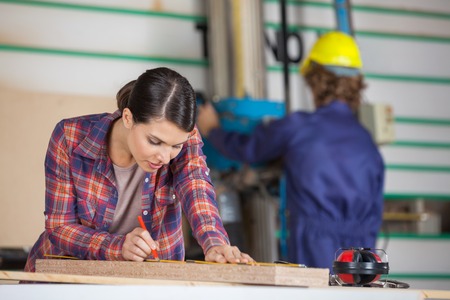 Carpenter Marking On Wood With Pencilの写真素材