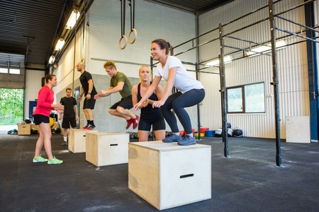 Athletes Doing Box Jumps At Gymの写真素材