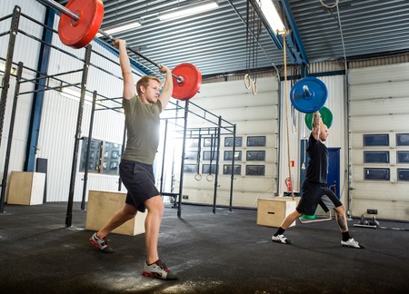 Athletes Exercising With Barbellsの写真素材