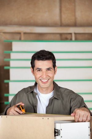 Carpenter Measuring Cabinet With Tapeの写真素材