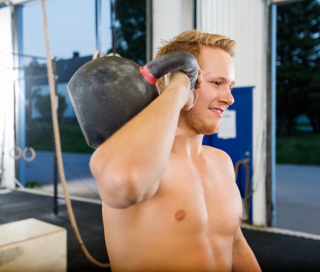 Man Exercising With Kettlebell In Gymの写真素材
