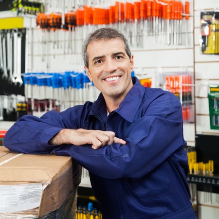 Worker Leaning On Tool Package In Hardware Shopの写真素材