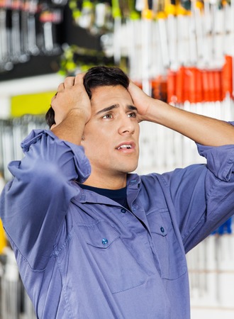 Confused Customer With Hands On Head In Hardware Shopの写真素材