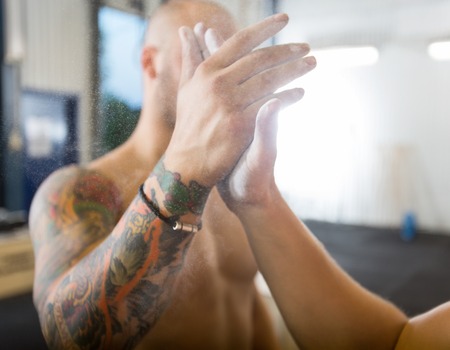Athletes Giving High-Five At Gymの写真素材