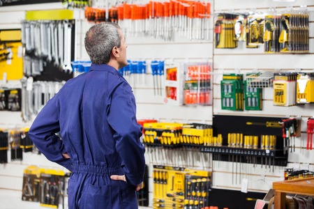 Worker With Hands On Hip In Hardware Storeの写真素材