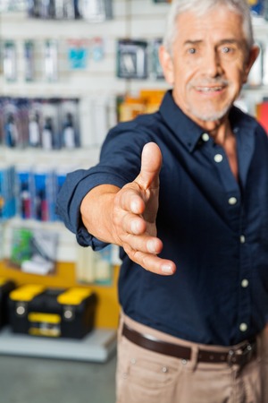 Man Gesturing Handshake In Hardware Storeの写真素材