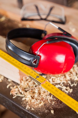 Closeup of ruler and ear protectors in workshopの写真素材