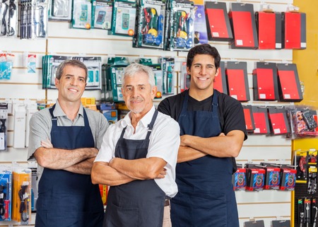 Salesmen Standing Arms Crossed In Hardware Shopの写真素材