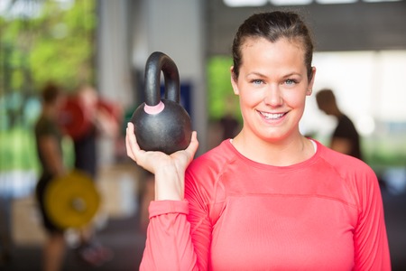 Fit Woman Lifting Kettlebell At Gymの写真素材