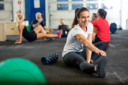 Woman Doing Stretching Exercise At Cross Training Boxの写真素材