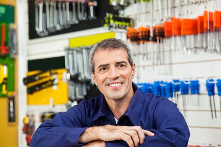 Male Worker Leaning In Hardware Shopの写真素材