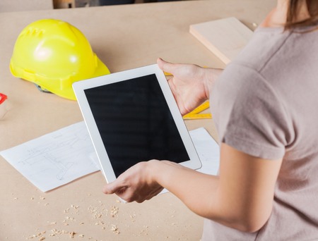 Architect Holding Digital Tablet In Workshopの写真素材