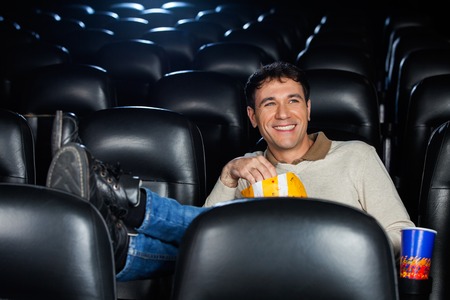 Relaxed Happy Man Watching Movieの写真素材