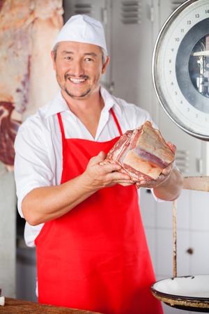 Butcher Showing Meat In Butcheryの写真素材