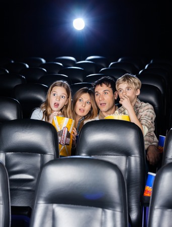 Amazed Family Watching Movie In Theaterの写真素材