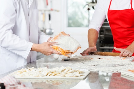 Chefs Preparing Ravioli Pasta At Kitchen Counter